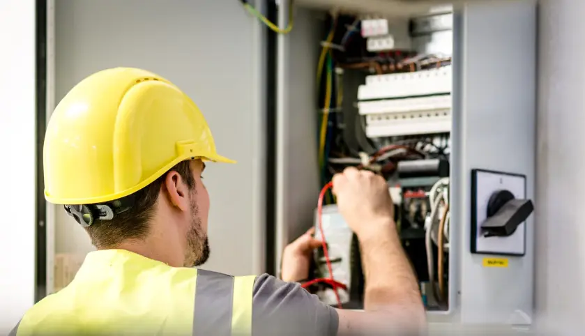 Licensed property inspector examining electrical panel and circuit breakers during comprehensive Dallas rental property safety evaluation